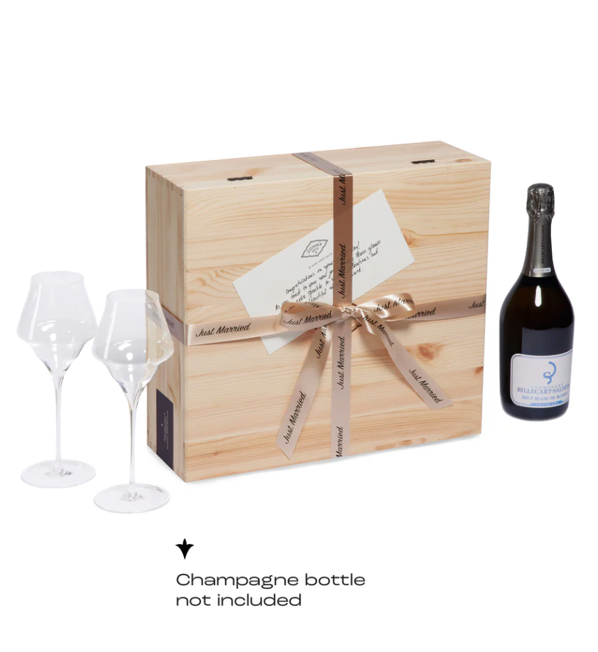 A wooden box with champagne glasses and a gift ribbon, indicating it is a wedding gift set. A champagne bottle is not included.