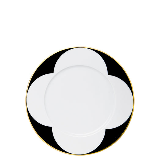 A black and white geometric patterned plate with gold trim.