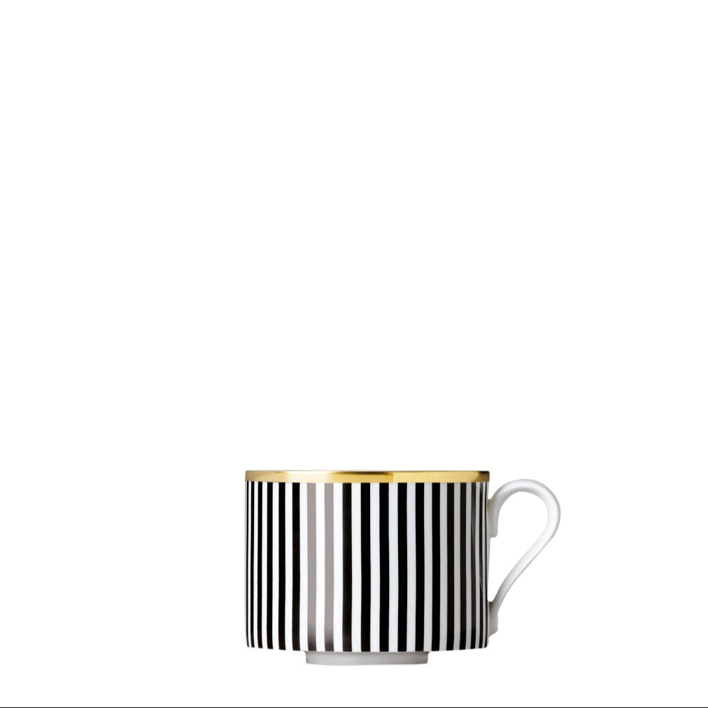 A black and white geometric patterned porcelain coffee cup with gold accents on a white background.