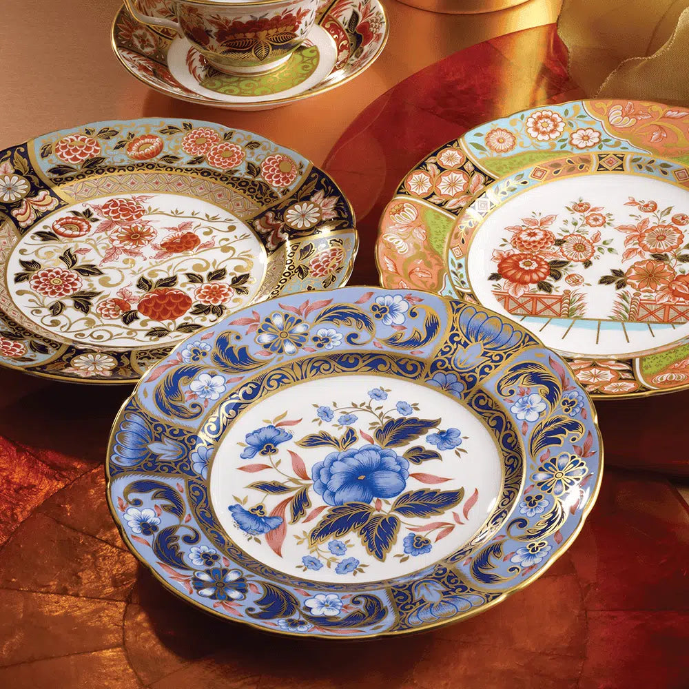 A set of ornate Imari Accent plates with bold colors and floral patterns, featuring 22 carat gold accents.