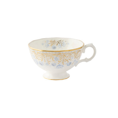 A fine bone china cup with blue flowers and a gold border on a white background.