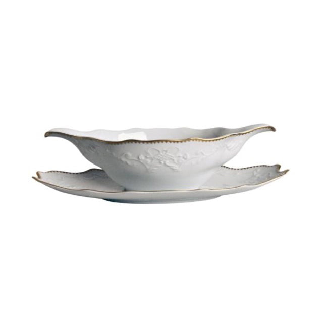 A white porcelain gravy boat with gold banding and floral embossing, accompanied by a matching stand.
