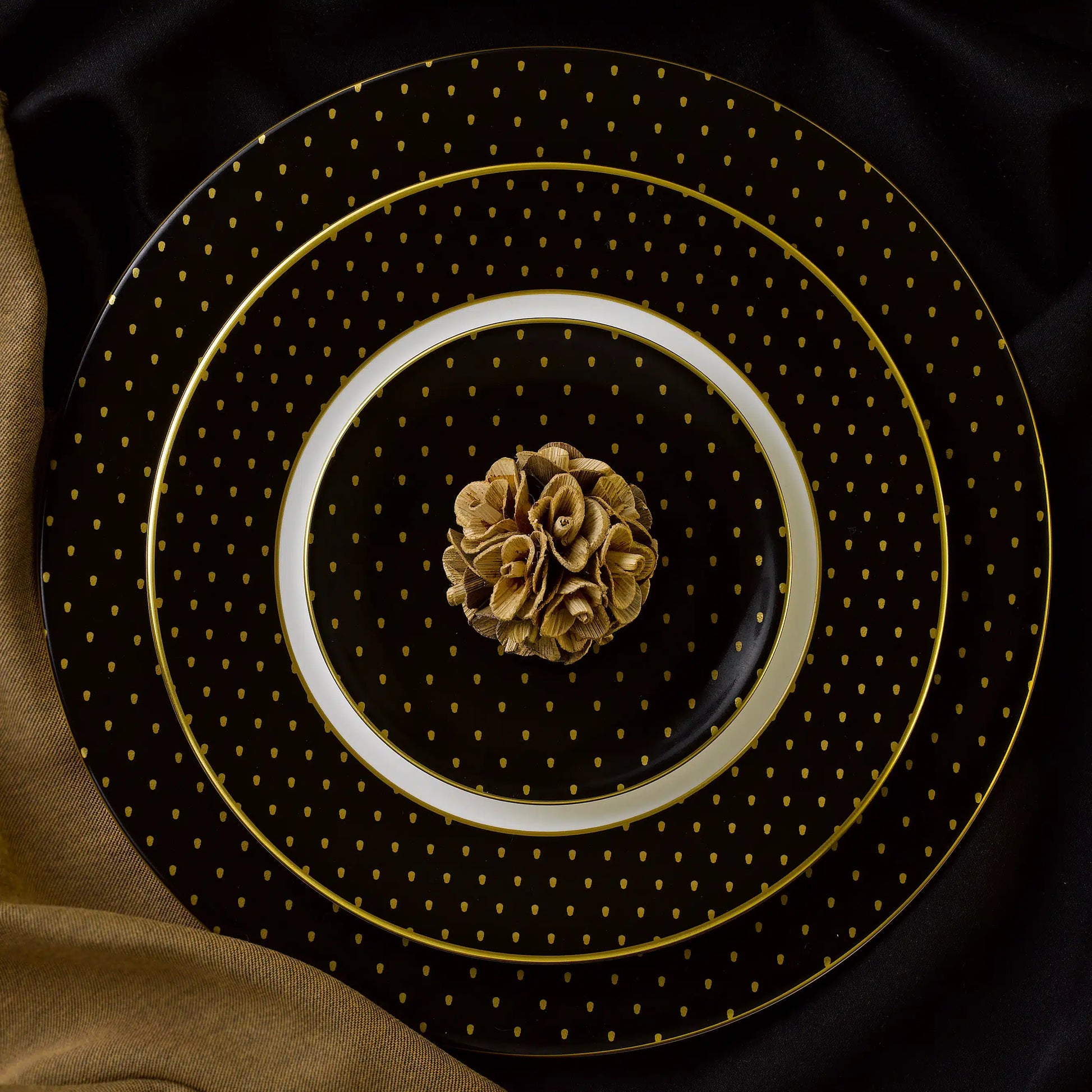 A set of black fine bone china plates with gold skulls.