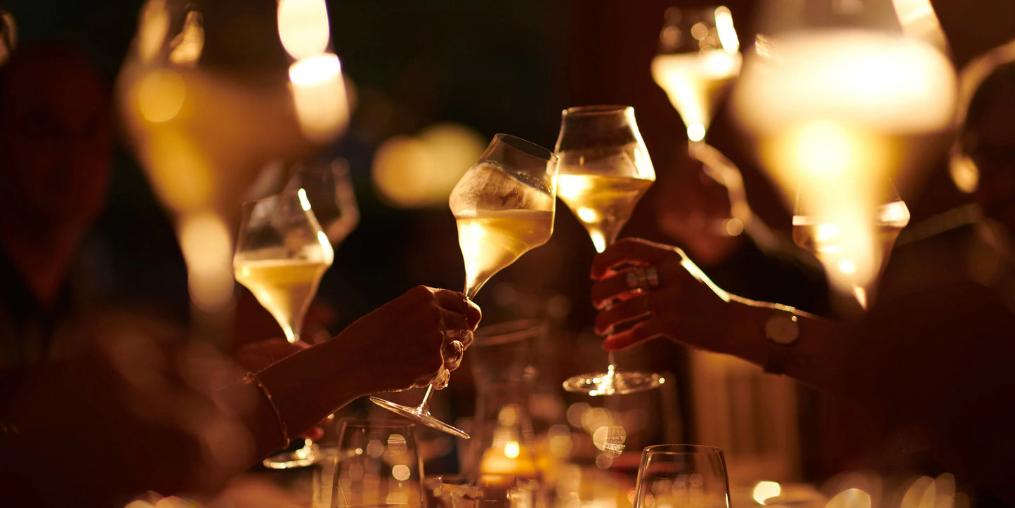 People clinking glasses of champagne at a festive event