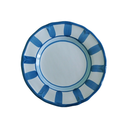 Round plate with blue and white striped design on a white background