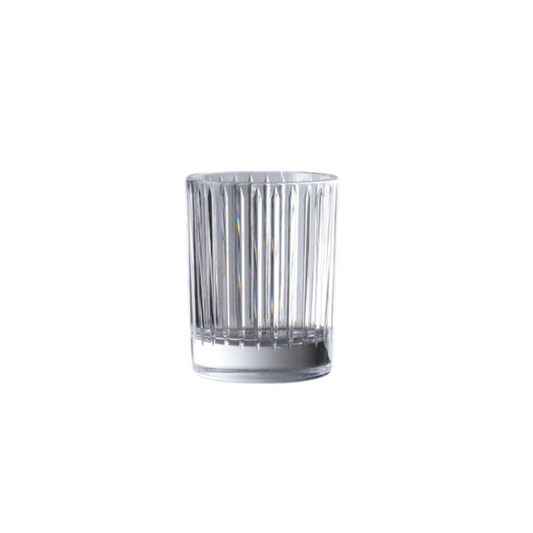 Clear glass tumbler with ribbed design on a white background