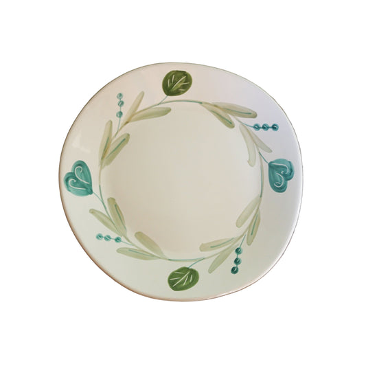 Decorative plate with green leaf patterns 