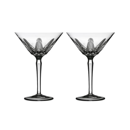 Two clear crystal martini glasses with cut design on a white background