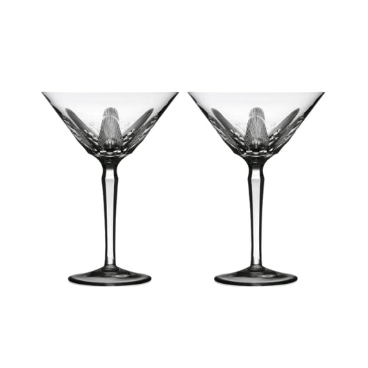 Two clear crystal martini glasses with cut design on a white background