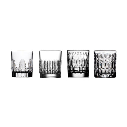 Four crystal shot glasses with different cuts on a white background