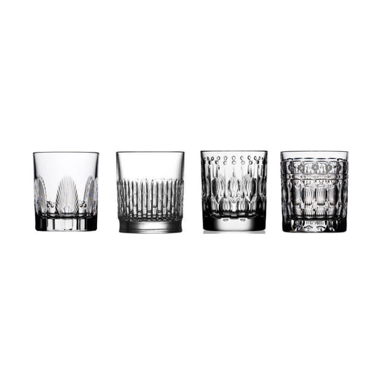 Four crystal shot glasses with different cuts on a white background