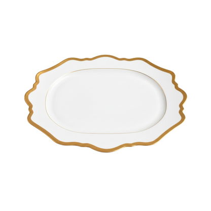 White porcelain platter with gold rim on a white background
