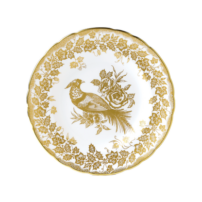 Decorative plate with gold bird and floral design on a white background
