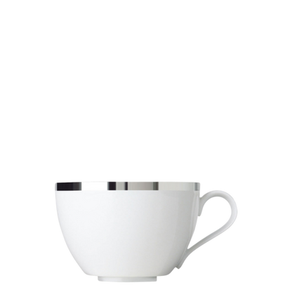 White porcelain teacup with a platinum rim on a white background