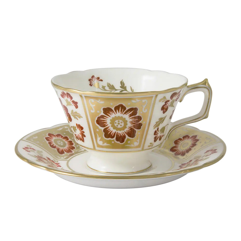 Decorative teacup and saucer with floral patterns on a white background