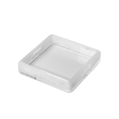 A square, acrylic serving tray with a white surface.