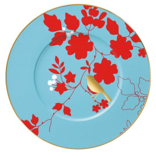 A round porcelain buffet plate with a blue background and red floral hand-gilded motifs along with a gold bird illustration in the center.