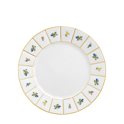 A white porcelain plate with gold trim and small floral decorations arranged in a pattern around the edge.