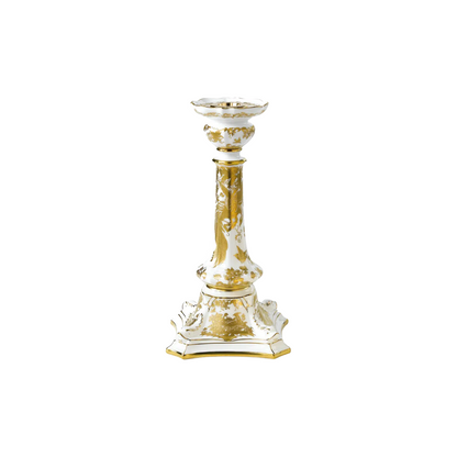 Decorative candlestick with gold and white design on a white background