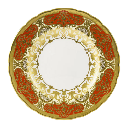 Decorative plate with gold and red patterns on a white background