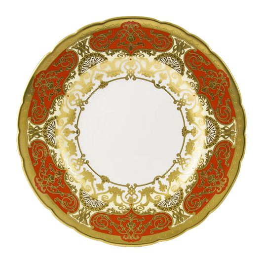 Decorative plate with gold and red patterns on a white background