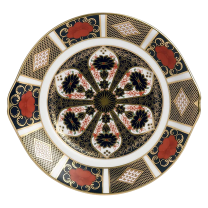 Decorative plate with intricate gold, black, and red patterns on a white background