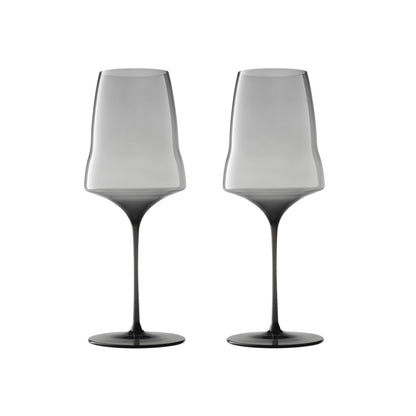 Two modern wine glasses with a smoky translucent design, fading from light gray at the wide bowl to dark charcoal at the base, shown side-by-side on a white background.