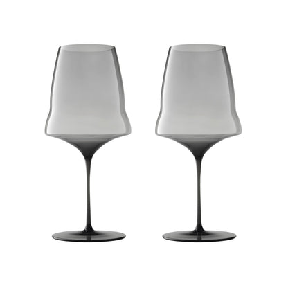 Two modern wine glasses with a gradient smoky gray design, transitioning from light gray at the top to dark gray at the base and stem, shown on a solid white background.