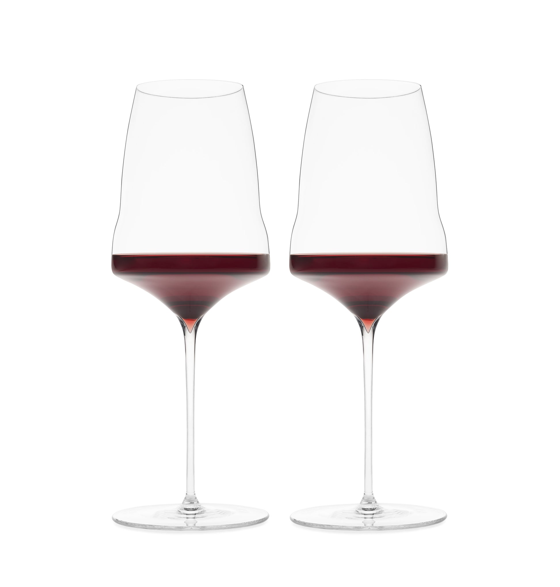 Two premium hand-blown wine glasses filled with red wine on a white background