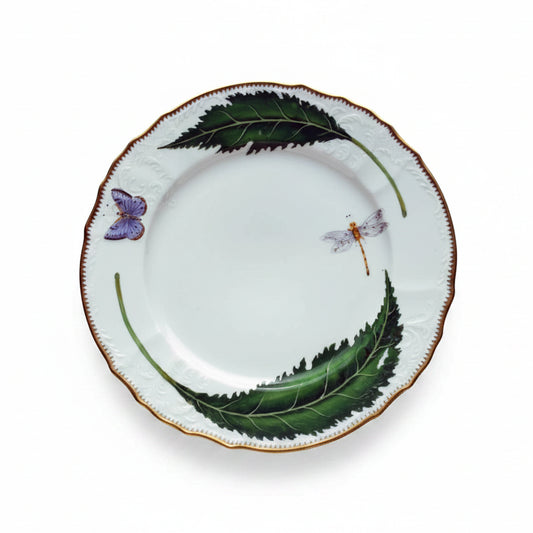 Decorative plate with green leaves and butterflies on a white background