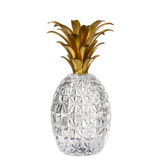 A gold-colored acrylic pineapple-shaped cutlery holder.