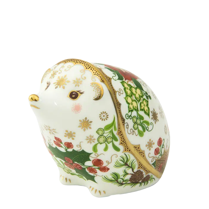 Decorative ceramic hedgehog figurine with floral patterns on a white background