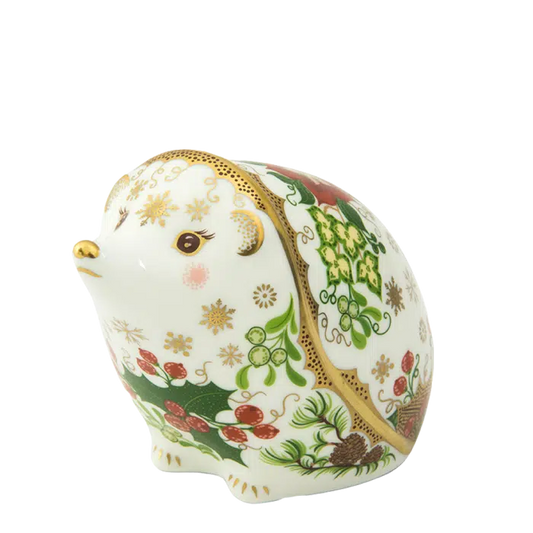Decorative ceramic hedgehog figurine with floral patterns on a white background