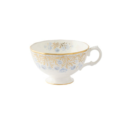 A fine bone china cup with blue flowers and a gold border on a white background.