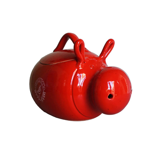 Red ceramic roaster shaped like a pig