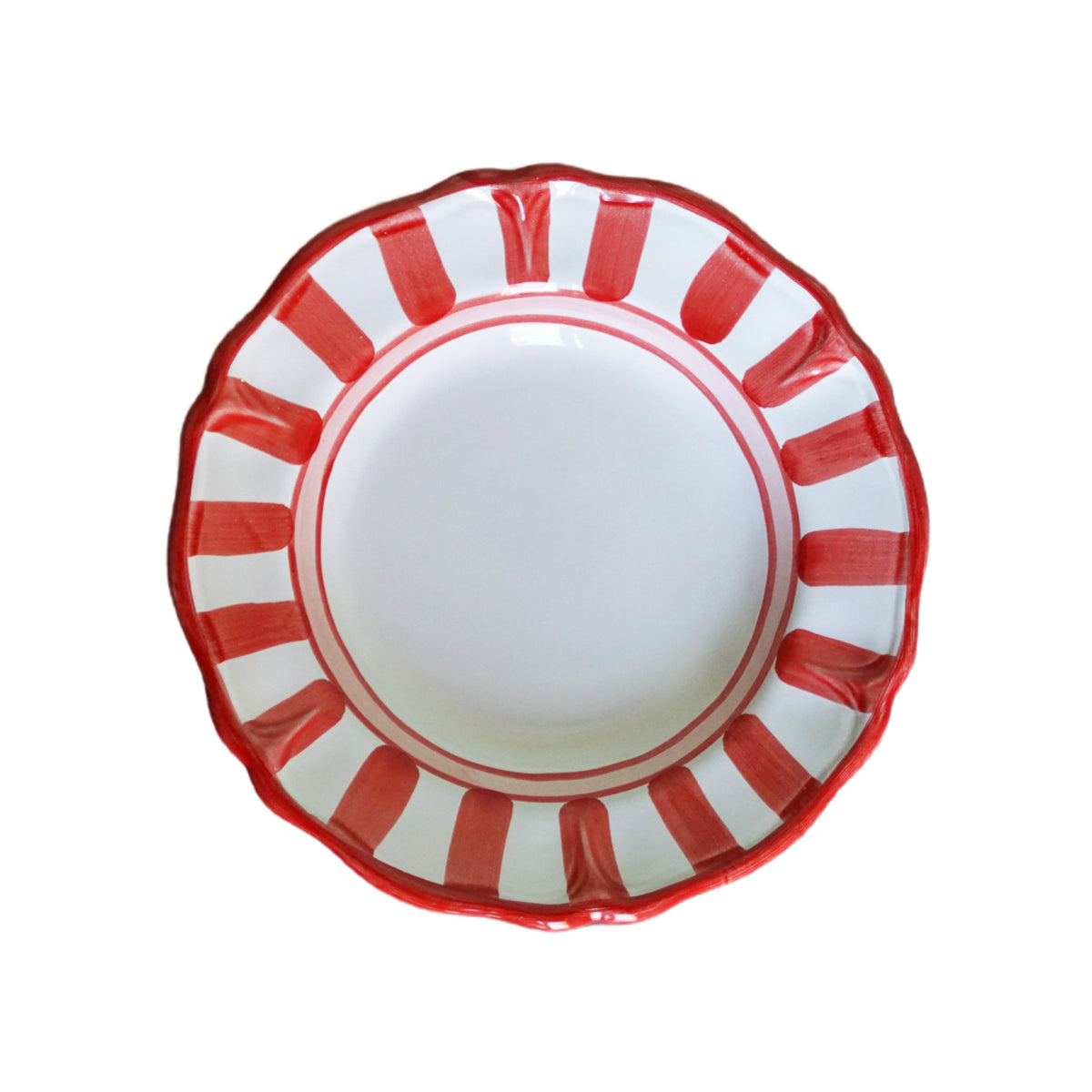 White hand-made ceramic plate with red striped rim on a white background
