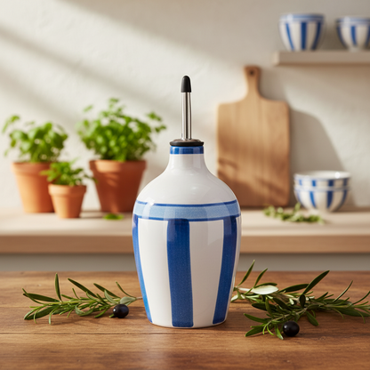 White and blue striped ceramic oil bottle on a wooden surface with kitchen background