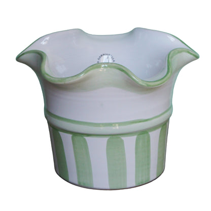 Ceramic planter with green stripes on a white background