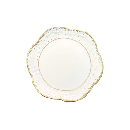 Decorative plate with gold rim and intricate detailing on a white background