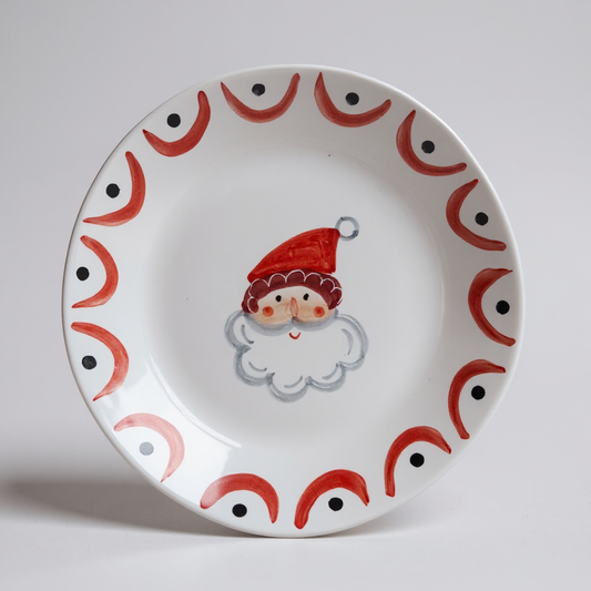 Decorative plate with Santa wearing a red hat on a white background