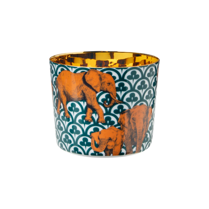 A multicolored porcelain champagne tumbler with a gold interior, decorated with orange elephant patterns against a blue background.