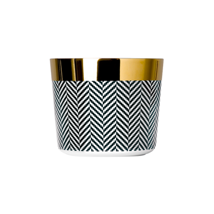 A black and white porcelain champagne tumbler with a gold rim and interior, featuring a geometric pattern.