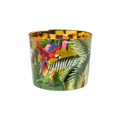 A multicolored luxury porcelain champagne tumbler with a gold interior and a design that includes jungle foliage and a colorful parrot.