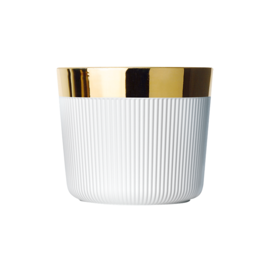 A matte white porcelain champagne tumbler with a gold rim and interior, against a plain background.