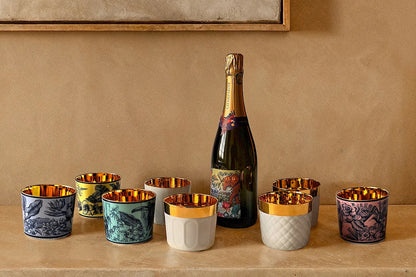 Bottle of champagne with luxury porcelain tumblers with 24k gold interiors 