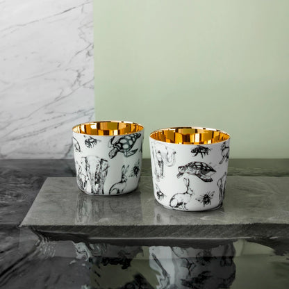 Porcelain champagne tumblers with a black and white animal design in partnership with Barbara Strum