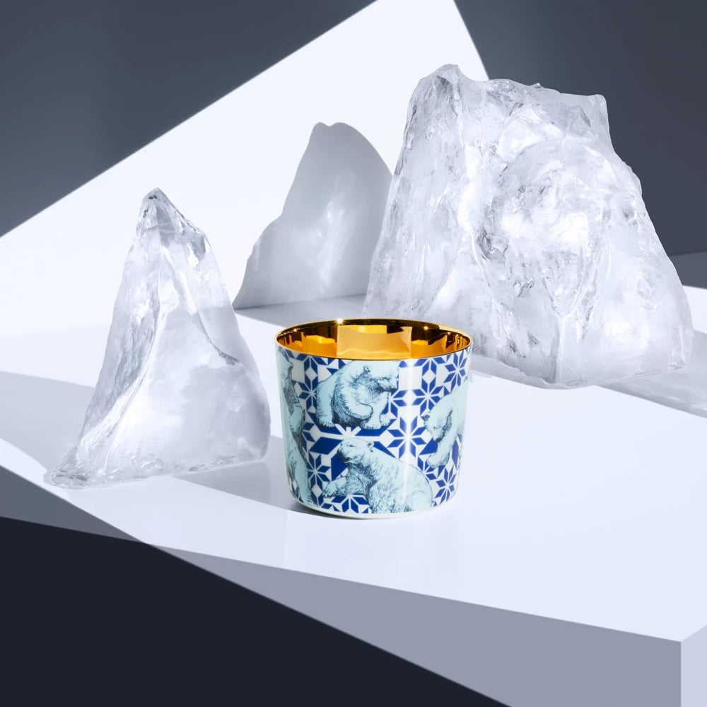 Porcelain champagne tumbler with polar bear design sitting next to iceburgs
