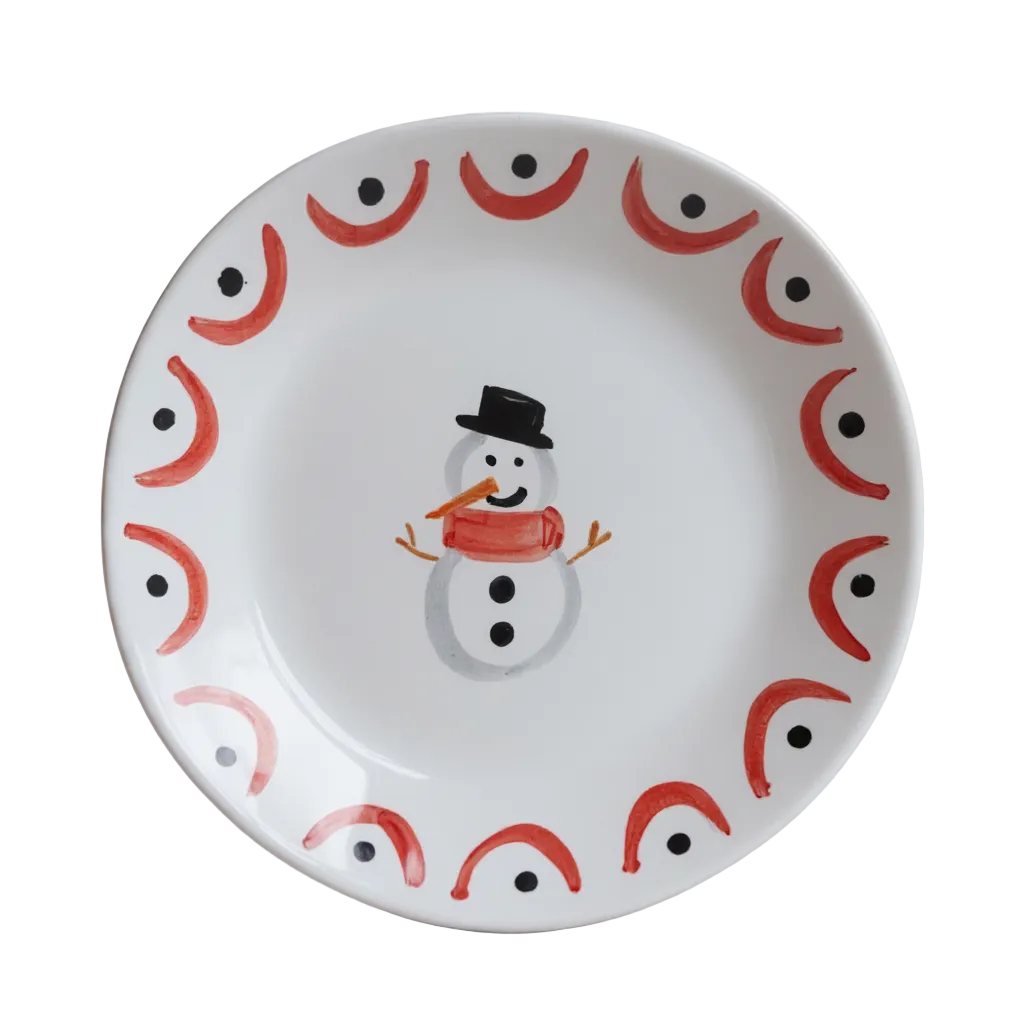 Decorative handmade ceramic plate with a snowman design and red and black patterns on a white background