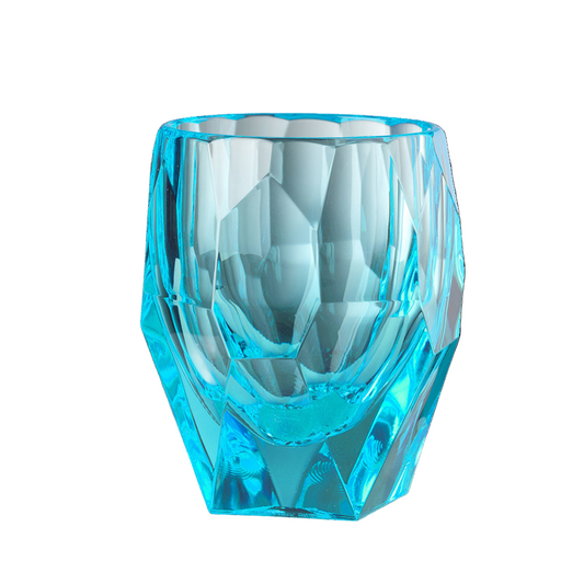 Turquoise acrylic tumbler with faceted design on a white background