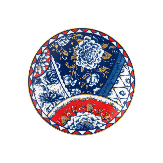 Decorative plate with floral patterns in blue, red, and white on a white background
